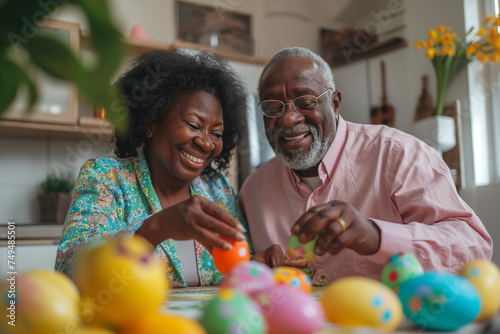 An African-American elderly couple paints eggs for Easter