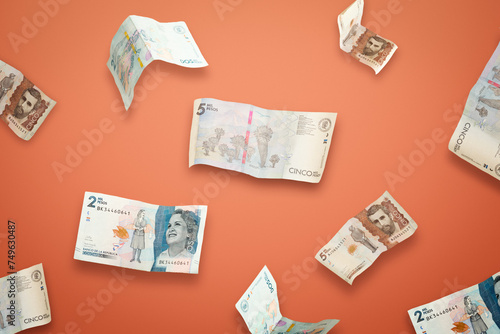Illustration of 2000 and 5000 Colombian pesos falling and flying in different angles and orientations isolated on orange background. Investment and saving concept.