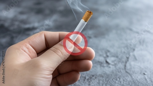 Hand refuses to accept a cigarette offer in close-up against a gray background.