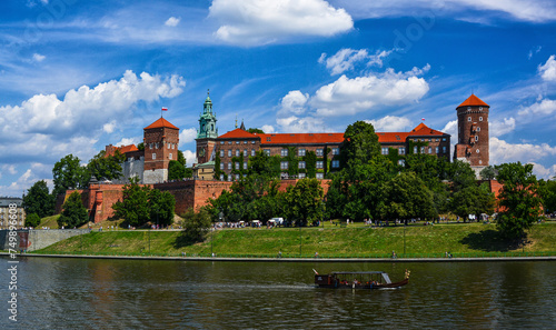 Front view of Wawel castle in Krakow, Poland with boats on Vistula river at summer time.