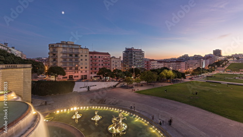 Panorama showing lawn at Alameda Dom Afonso Henriques and the Luminous Fountain aerial day to night timelapse in Lisbon.