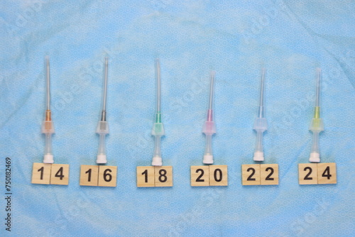 Intravenous catheters aligned in a sterile surface aligned by size 