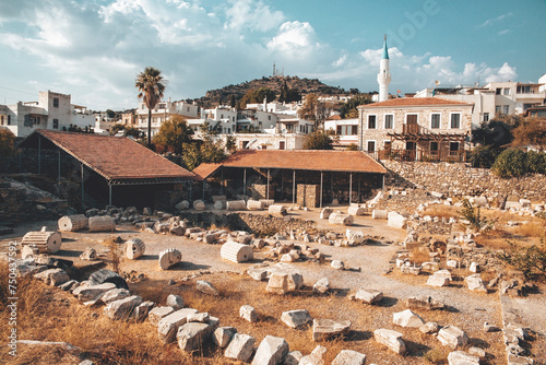The ruins of the Mausoleum at Halicarnassus (Tomb of Mausolus), Cityscape at background. Toning. Bodrum, Turkiye (Turkey)
