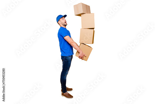 Full body length size, side profile view of handsome scared, shocked bearded deliver in uniform holding four large big flying up in air boxes in arms, isolated over bright vivid yellow background