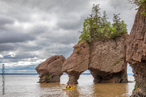 Kayaking at The flowerpot rock formations at Hopewell Rocks, Bay of Fundy, New Brunswick. The extreme tidal range of the bay makes them only accessible at low tide.