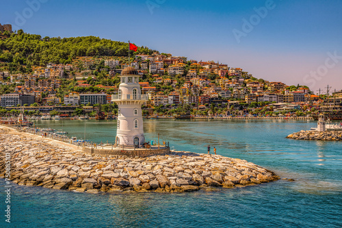 Alanya, Turkey. Old lighthouse in the harbor of the Turkish city and view of the old fortress and the Red Tower.