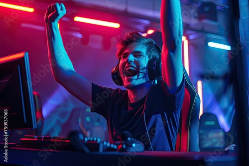 happy male cyber sport gamer raising hand, celebrating success participating in professional eSports tournament