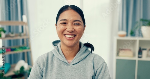 Portrait, wellness or happy woman in home to relax in living room on holiday in hotel, house or apartment. Face, pride or Asian person with peace, smile or confidence on break to rest for alone time
