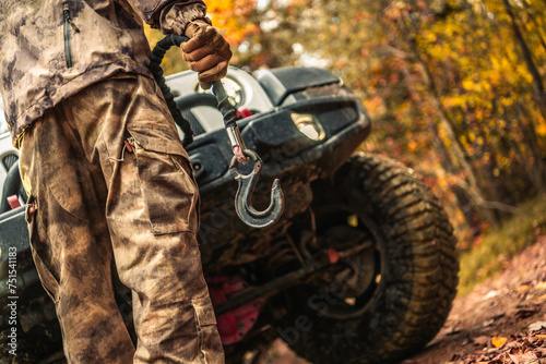 Driver Preparing Wrench Hook For the Car Recovery During Off Road Muddy Drive