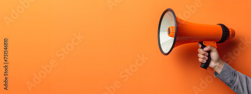 Hand holding a megaphone announces sales and discounts, on a vibrant orange background. Marketing and commercial concept banner with copy space, made with Generative AI.
