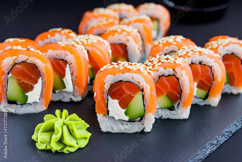 Delicious sushi on a dark background. Tasty sushi on a graphite plate. Sushi Filadelfia. Generative AI image.