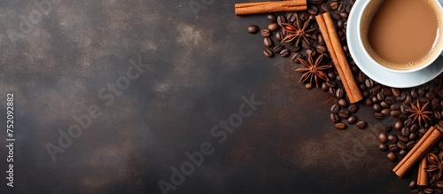 Rich Aroma of Coffee: Cinnamon and Coffee Beans Surround a Cup in Warmth