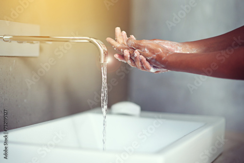 Hands, water and soap for cleaning with person in bathroom, hygiene and wellness for protection from germs. Bacteria, virus and disinfection at sink with foam, skincare and cosmetics in routine