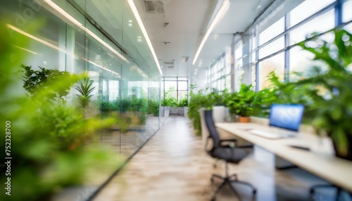 Blurred images of modern digital agency company empty glass big office interior plants