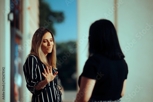 Woman Listening to her Friend Lies Making Stop Gesture Girl not trusting her manipulative best friend blocking communication 