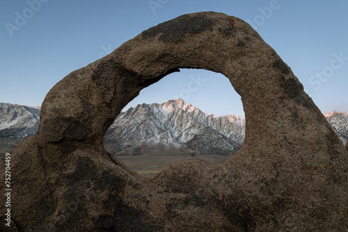 The Whitney Arch rock formation in the Alabama Hills frames Mt. Whitney and the Sierra Nevada range