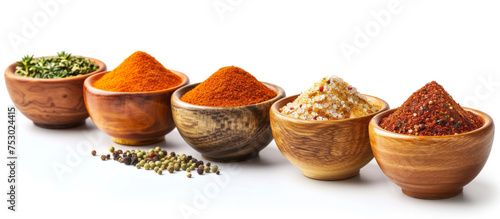 A row of bowls with different colored spices in them. The bowls are lined up next to each other, with the first bowl on the left and the last on the right
