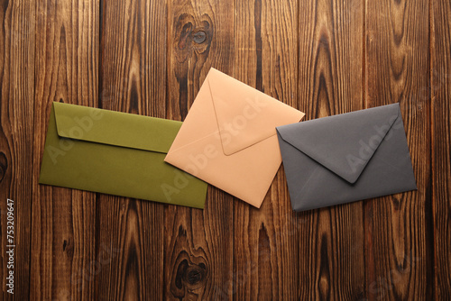 Colored envelopes on a wooden table. Top view