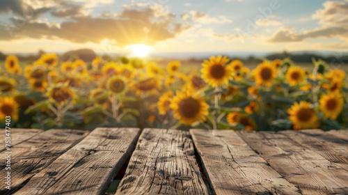 Blank wooden table top with blurred background of sunflower field Thriving image concept