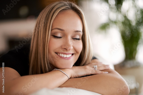Thinking, smile and woman relax on a sofa with peace, dreaming or eyes closed gratitudes in her home. Face, mindfulness and female person remember happy memory, reflection or resting in a living room
