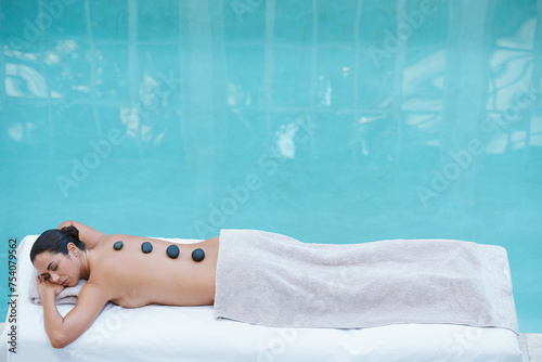 Spa, hot stone massage and woman at pool at hotel for health, zen wellness and luxury holistic treatment. Self care, relax or girl on table for body therapy, comfort and calm pamper service in mockup
