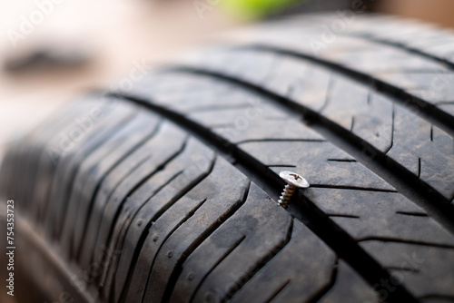 Car tire puncture due to running over a bolt