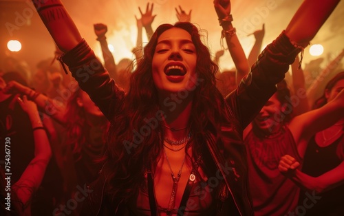 A multiracial woman with her arms raised high in the air, expressing joy and celebration