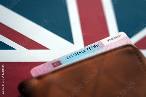 Residence Permit BRP card in purse on Union Jack flag close up