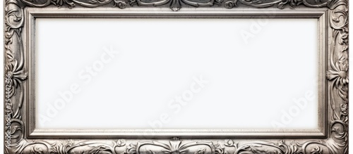 An ornate silver frame, suitable for paintings, mirrors, or photos, is displayed against a clean white background. The intricate details of the frame enhance its elegance and sophistication.