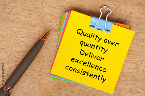 Quality over quantity. Deliver excellence consistently text on yellow notepad.