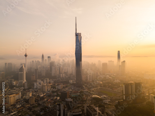 Aerial golden sunrise at Kuala Lumpur city skyline.