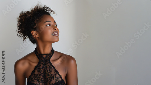 Afro elegant woman in black halterneck dress isolate on gray