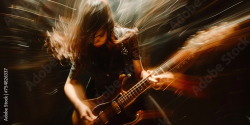 A dynamic shot of a female musician passionately playing electric bass guitar on a blurred stage.