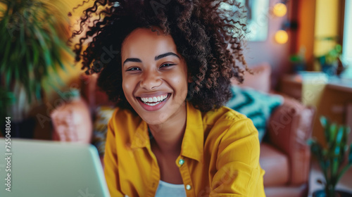 Happy smiling african american female working remotely from home at her laptop. Positive and flexible work culture. AI generated