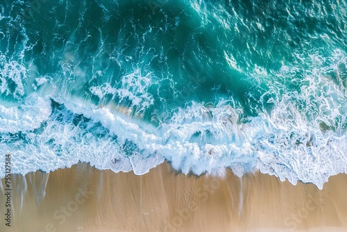 Aerial view of waves crashing on the beach Providing a breathtaking perspective of nature's power and beauty in a tranquil setting