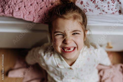 Portrait of cute girl smiling with gap-toothed grin, missing her baby teeth.