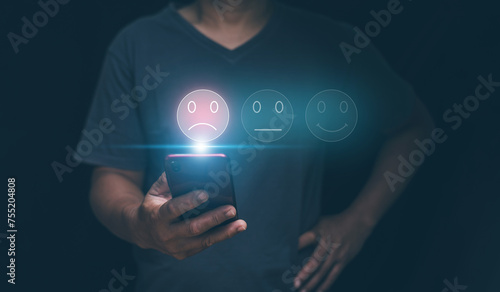 Customer experience dissatisfied concept, Businessman holding smartphone with sadness emotion face on screen, unhappy, Bad review, Low rating, Dissatisfied with products and services.