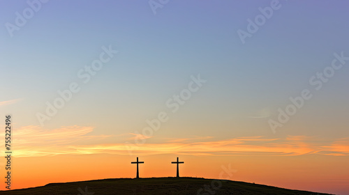 Two crosses on a hill with a vibrant sunset background creating a serene and contemplative silhouette scene