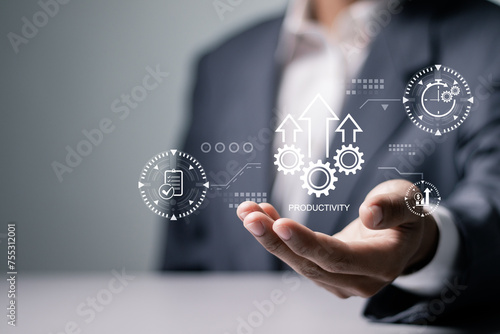 Process to increase productivity concept. Businessman holding productivity icon on virtual screen for industrial management in efficiency and efficient process. Lean cost and productivity growth.