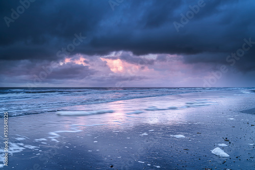 Seascape landscape during sunset with dramatic sky and dark clouds over the North Sea