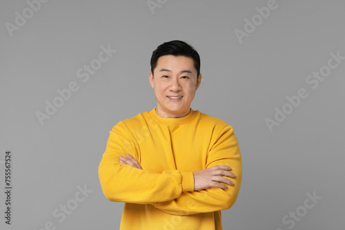 Portrait of happy man on grey background
