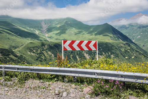 Turn sign on Georgian Military Highway in Caucasus mountains in Georgia