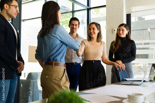 Businesswomen shaking hands and closing a business deal