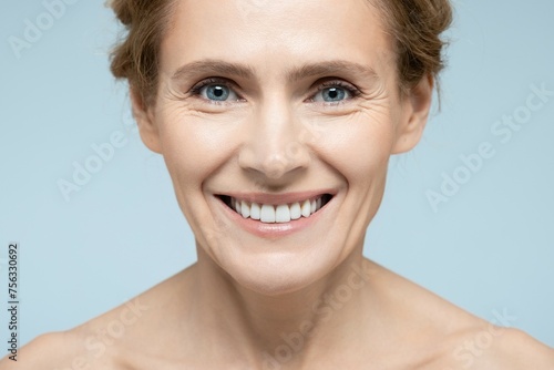 Beauty portrait of middle-age woman with perfect and shiny skin. Concept of skin care and aesthetic cosmetology