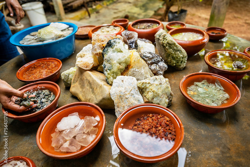 Exhibition of mined precious stone, many type and color in bowl and on table