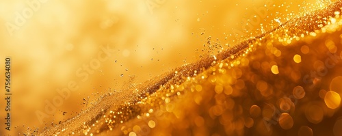 Golden bokeh lights and glitters on a warm background