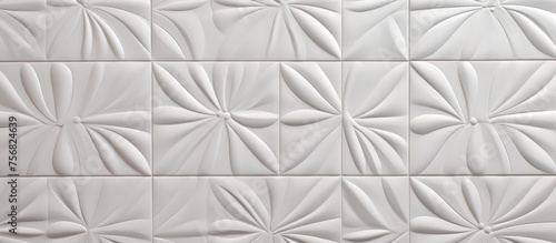 A close up of a rectangular white tile with a creative arts pattern on it, featuring tints and shades of brown and grey. The natural material resembles wood flooring
