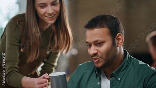 Girl giving coffee colleague sitting office coworking closeup. Man talking woman
