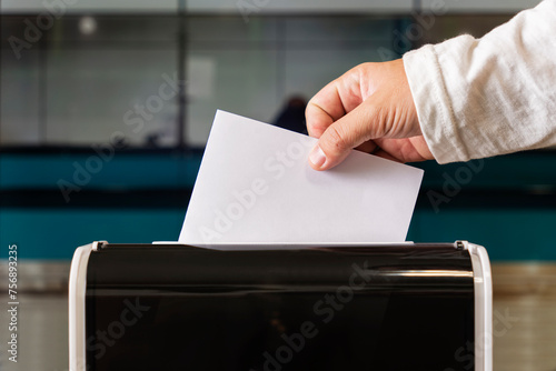 person casts her ballot during voting for parliamentary elections at a polling station