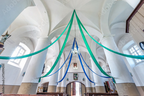 interior dome and looking up into a old gothic catholic church ceiling decorated with colored ribbons